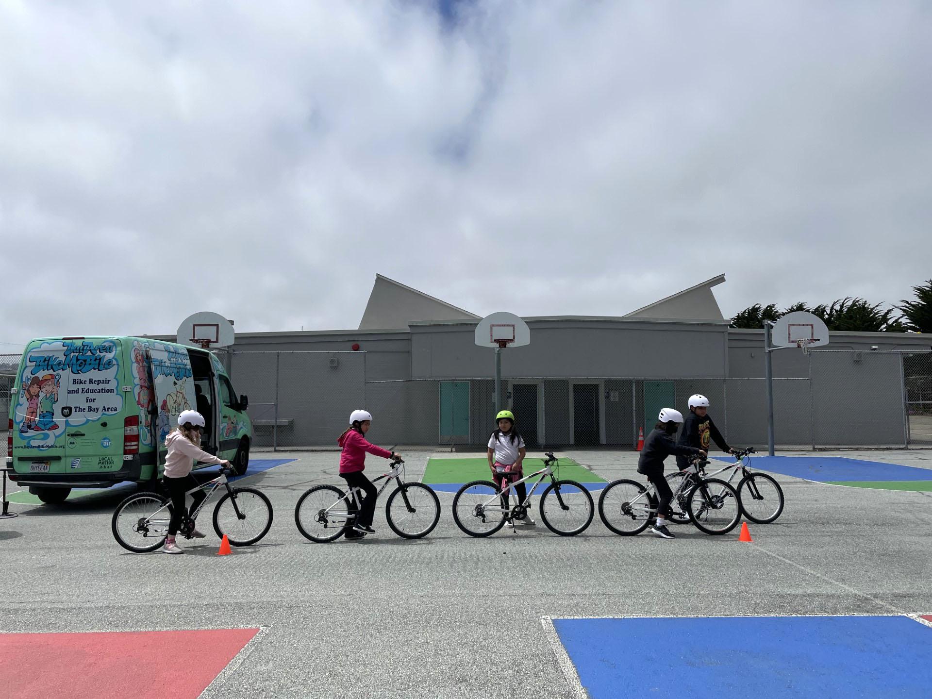Sunshine Garden Elementary School students get ready to test our their new bicycles during the city of South San Francisco's 2023 bike giveaway event.